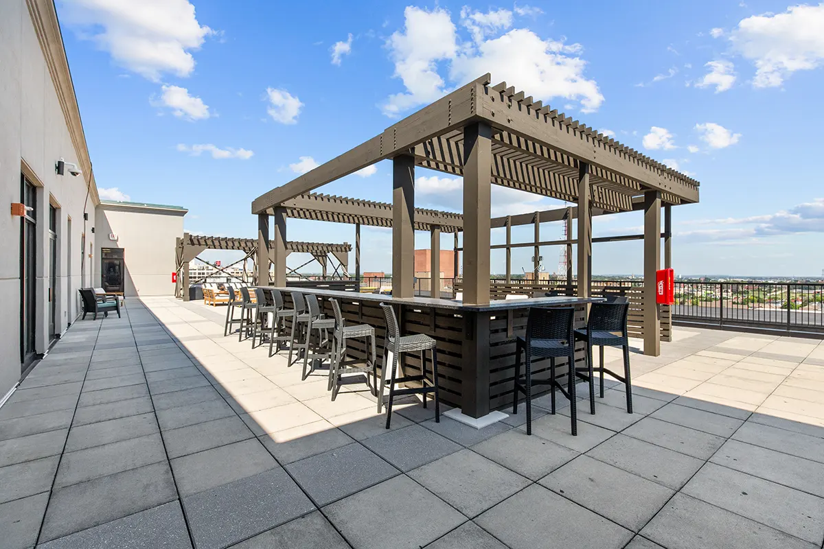 Rooftop Terrace Bar with stool seating on a sunny day from the roof of Six Cord Apartments
