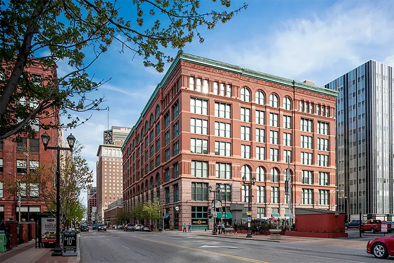 Close view of the brick exterior and large windows of Six Cord Apartments