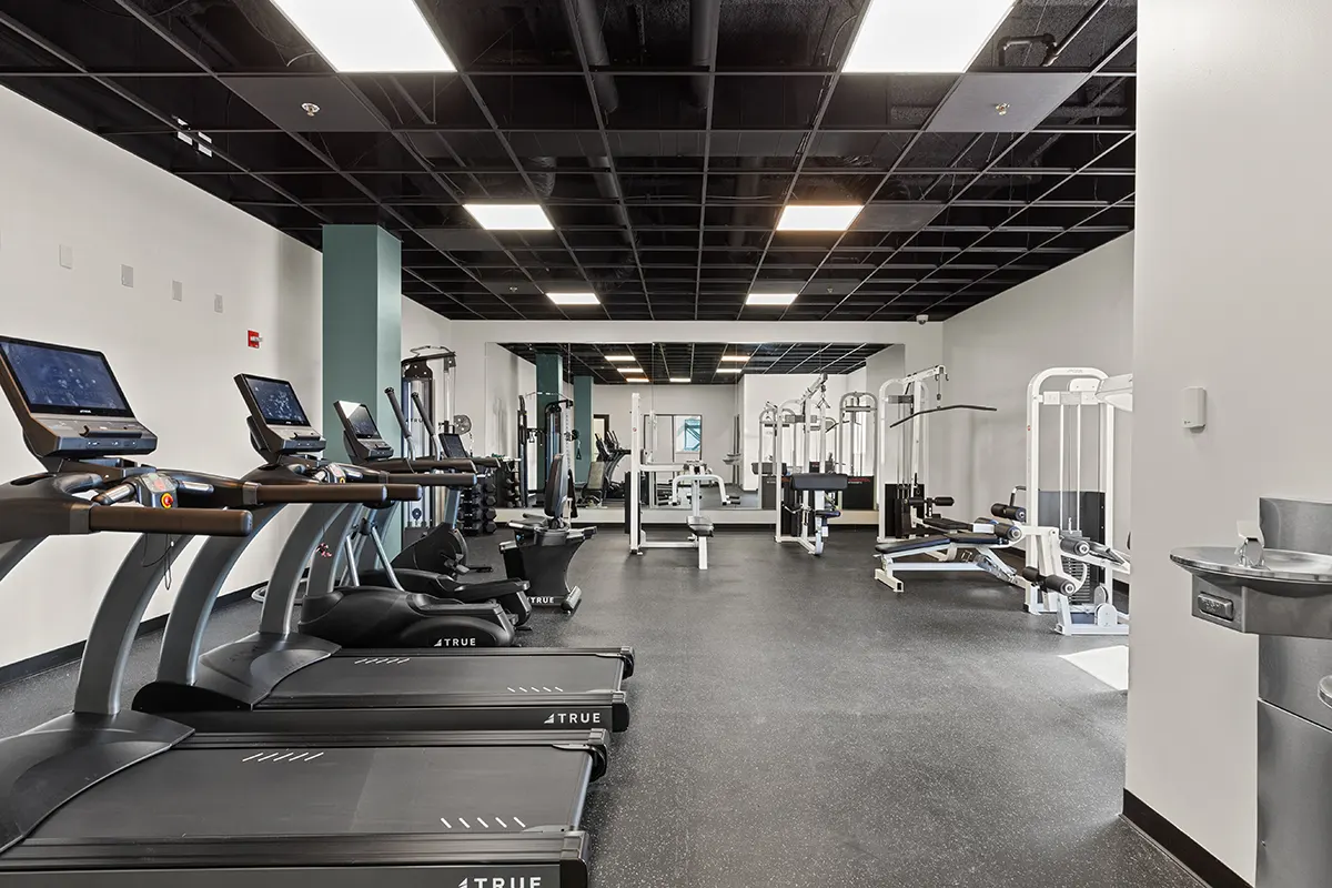 Wide shot of the Six Cord fitness center showing treadmills, strength training, ellipticals, and stretch space