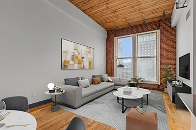 Loft-style apartment living room with large windows, wood slat ceilings, and exposed brick walls at Six Cord Apartments