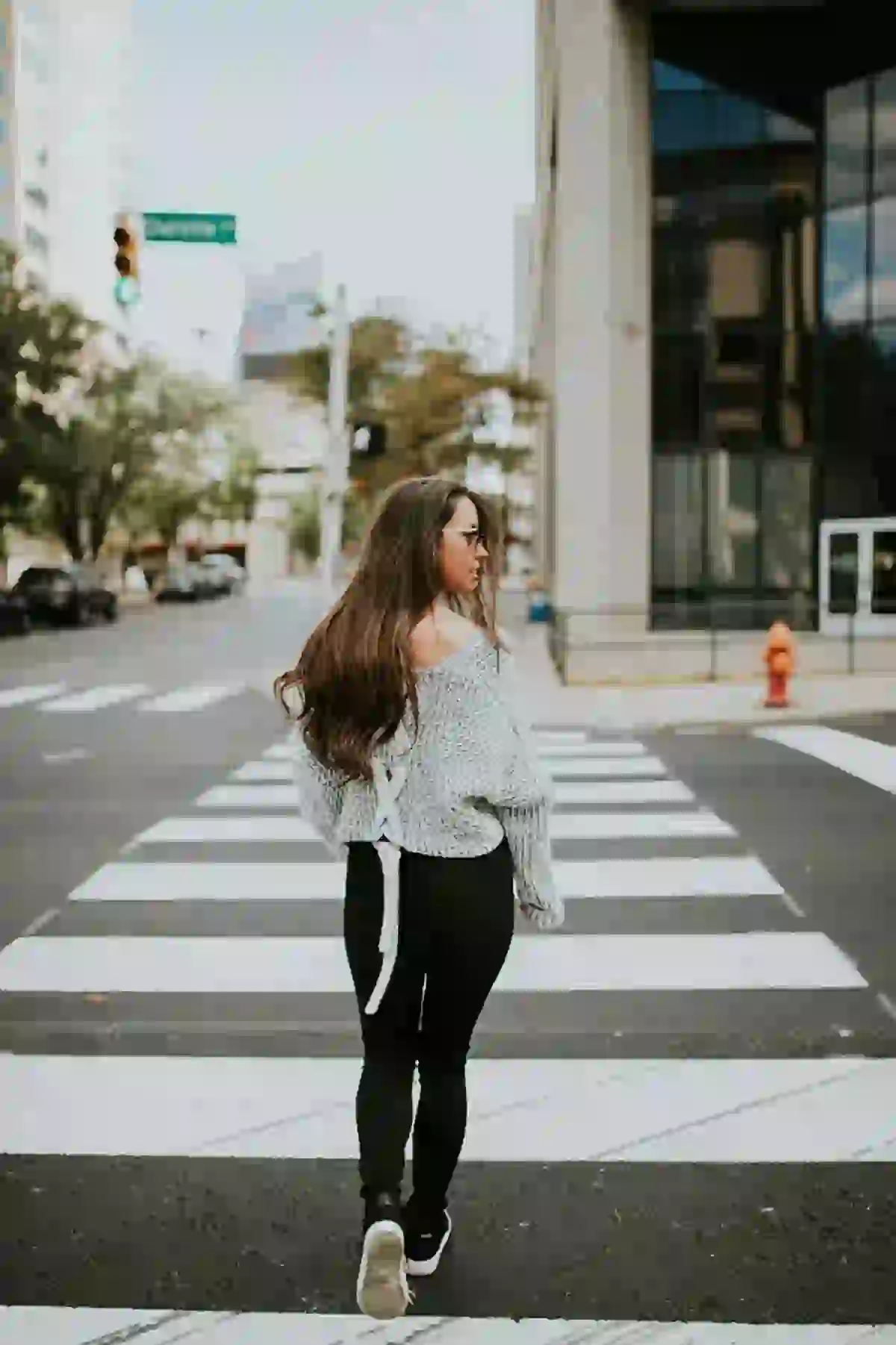 Young woman crossing a crosswalk on Washington Avenue in Downtown St. Louis, MO