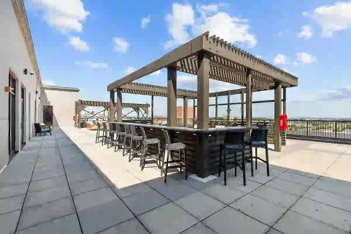 Rooftop Terrace Bar with stool seating on a sunny day from the roof of Six Cord Apartments