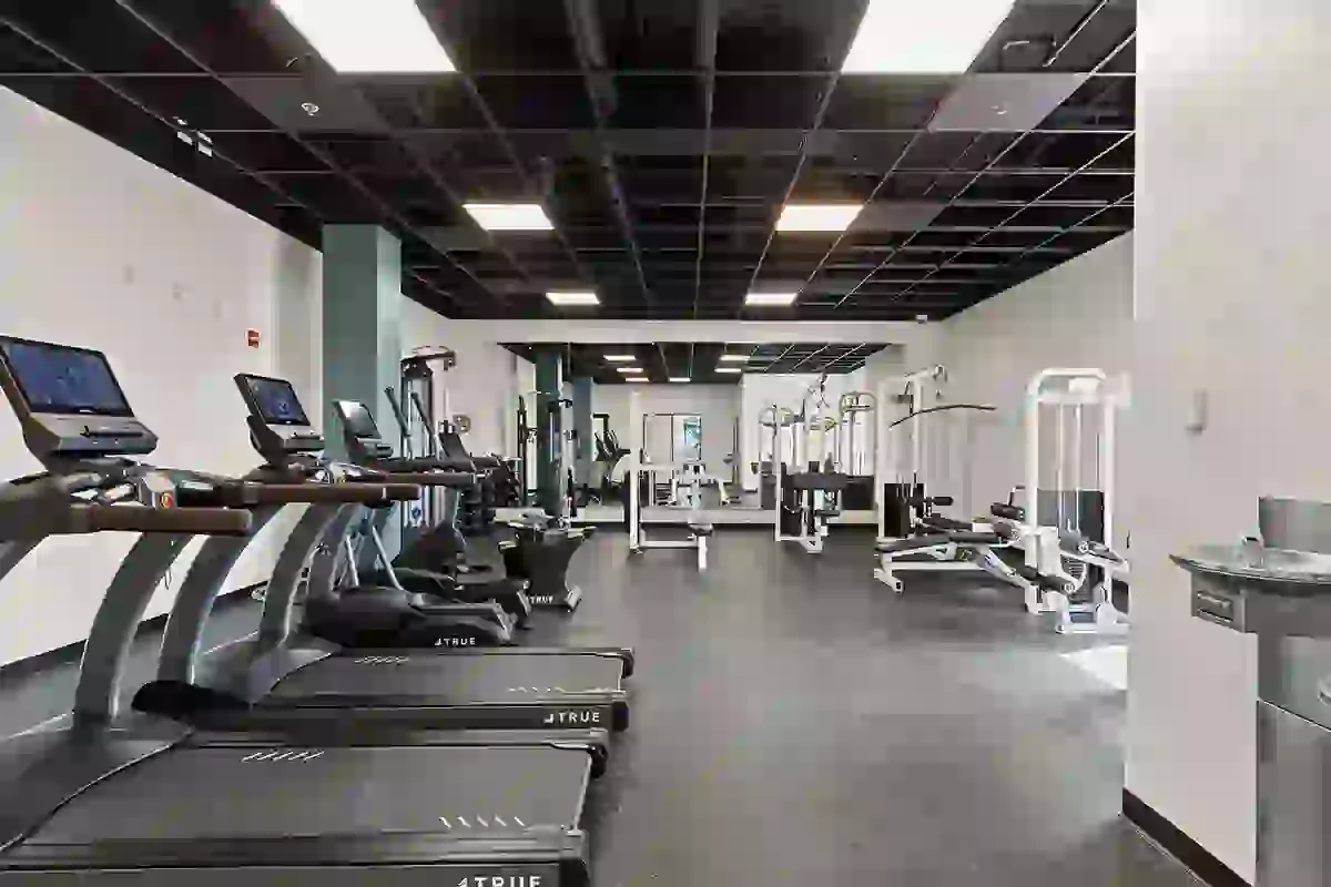 Wide shot of the Six Cord fitness center showing treadmills, strength training, ellipticals, and stretch space