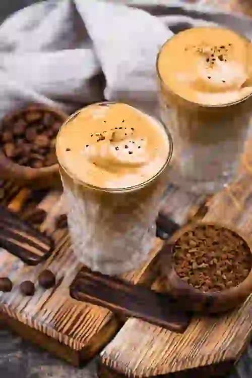 Iced coffee in glasses on wooden table