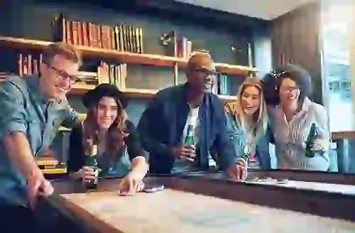 Group of friends playing shuffleboard in the Game Lounge