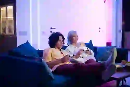 A couple watching a movie in the TV lounge at Six Cord Apartments
