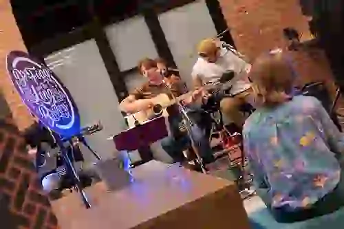 Live music with musicians playing acoustic guitar at Six Cord Apartments event
