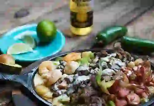 Close-up of Mexican food with lime, jalepno, and beer in background at Rosalita's Cantina