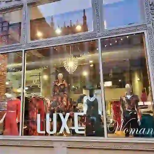 Storefront retail windows with clothing and mannequins at Luxe Department Store