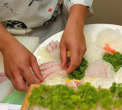 A close-up of sushi being prepared at Mizu Sushi