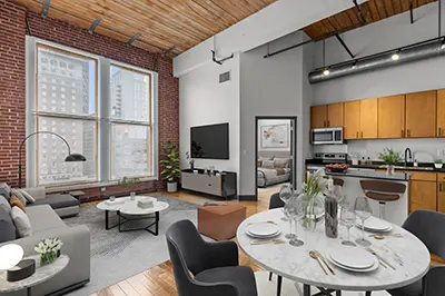Open-concept floor-plan with kitchen and living room leading to large windows with natural light and downtown city views